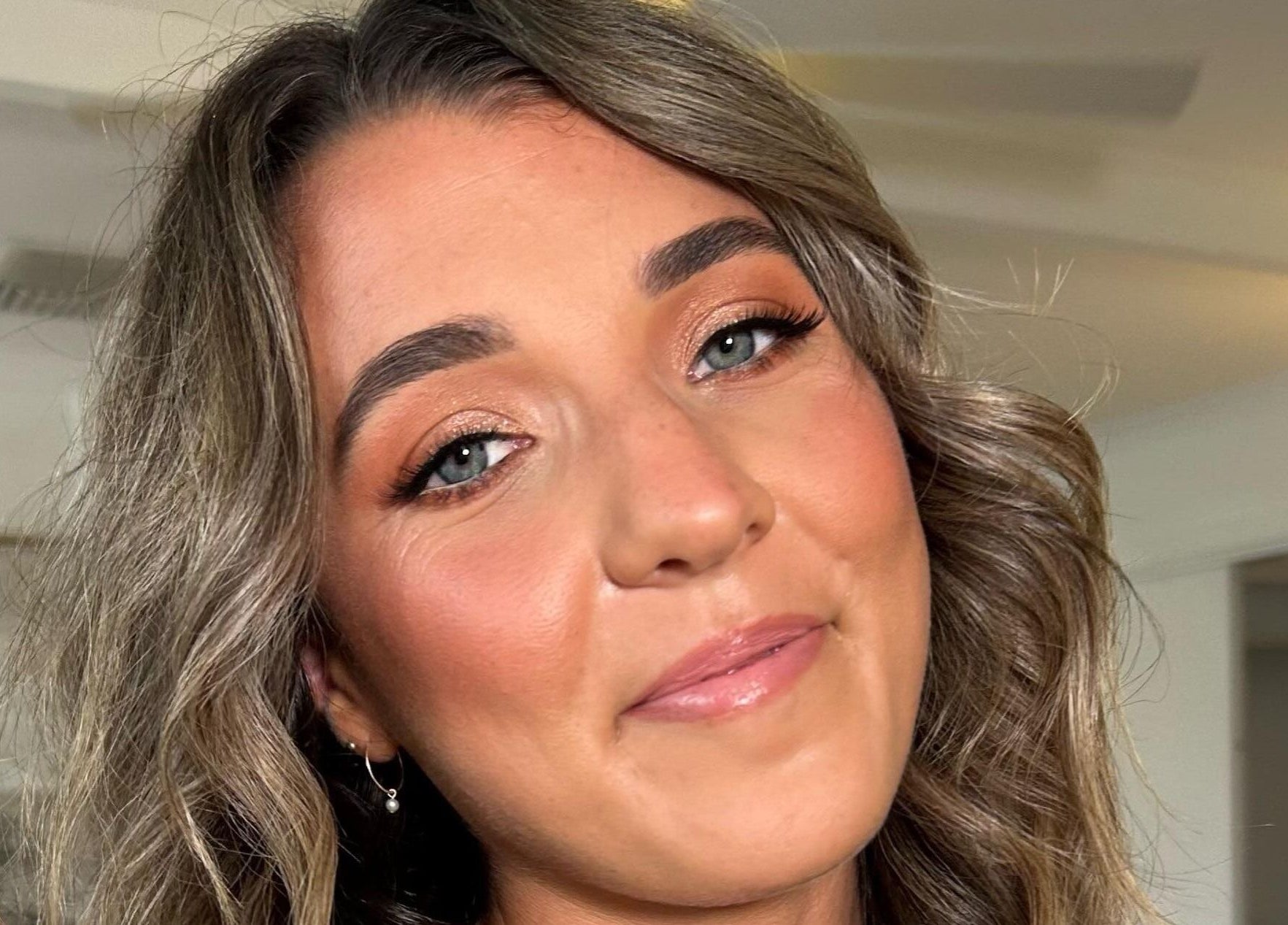 Smiling woman with elegant makeup at Charlotte J. Artistry, Brighton, South Australia, AU.