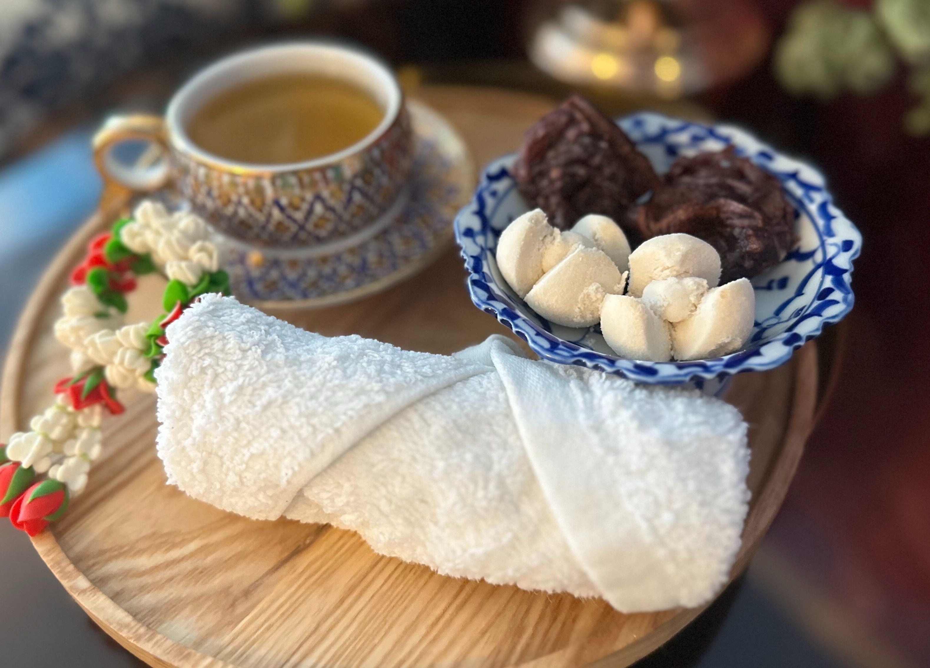 Rolled towel, tea, and snacks at Na-ka Thai Day Spa in Woolloongabba, Queensland, AU for a relaxing experience.