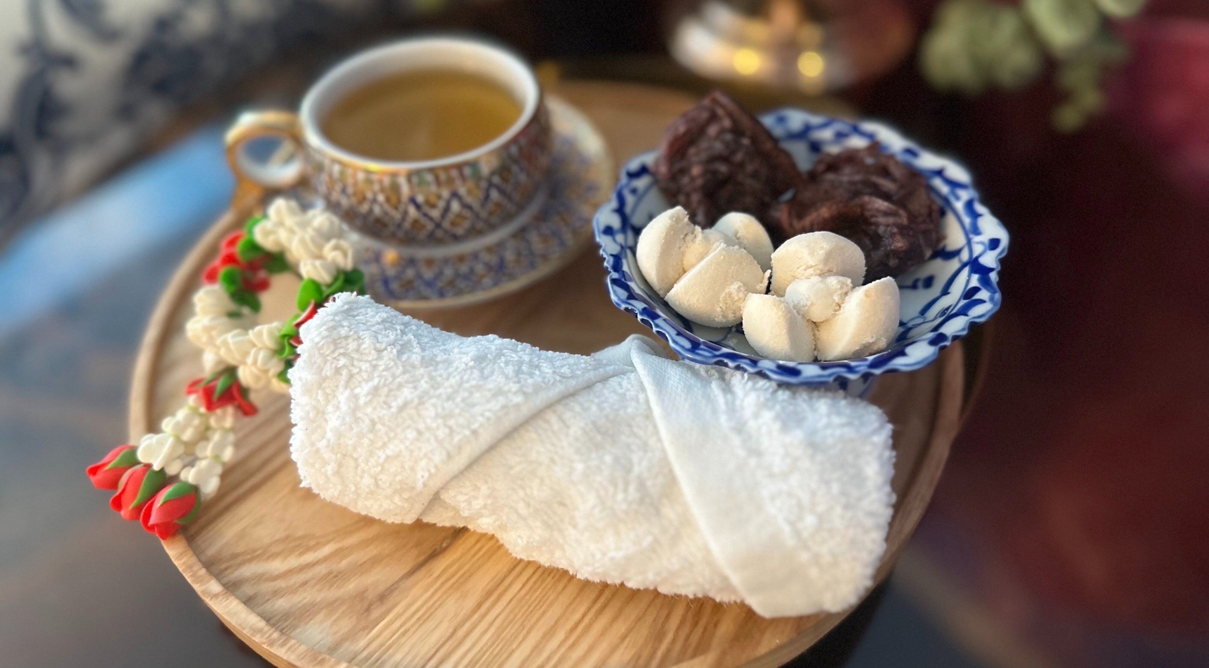 Rolled towel, tea, and snacks at Na-ka Thai Day Spa in Woolloongabba, Queensland, AU for a relaxing experience.