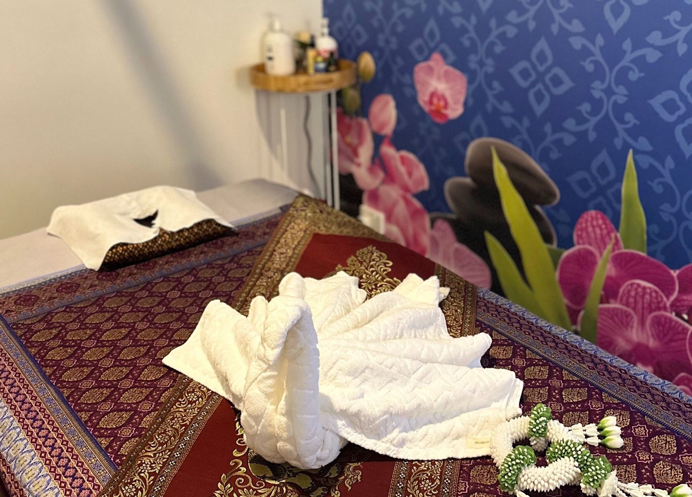 Tranquil massage room at Na-ka Thai Day Spa in Woolloongabba, Queensland, AU with ornate decor and calming ambience.