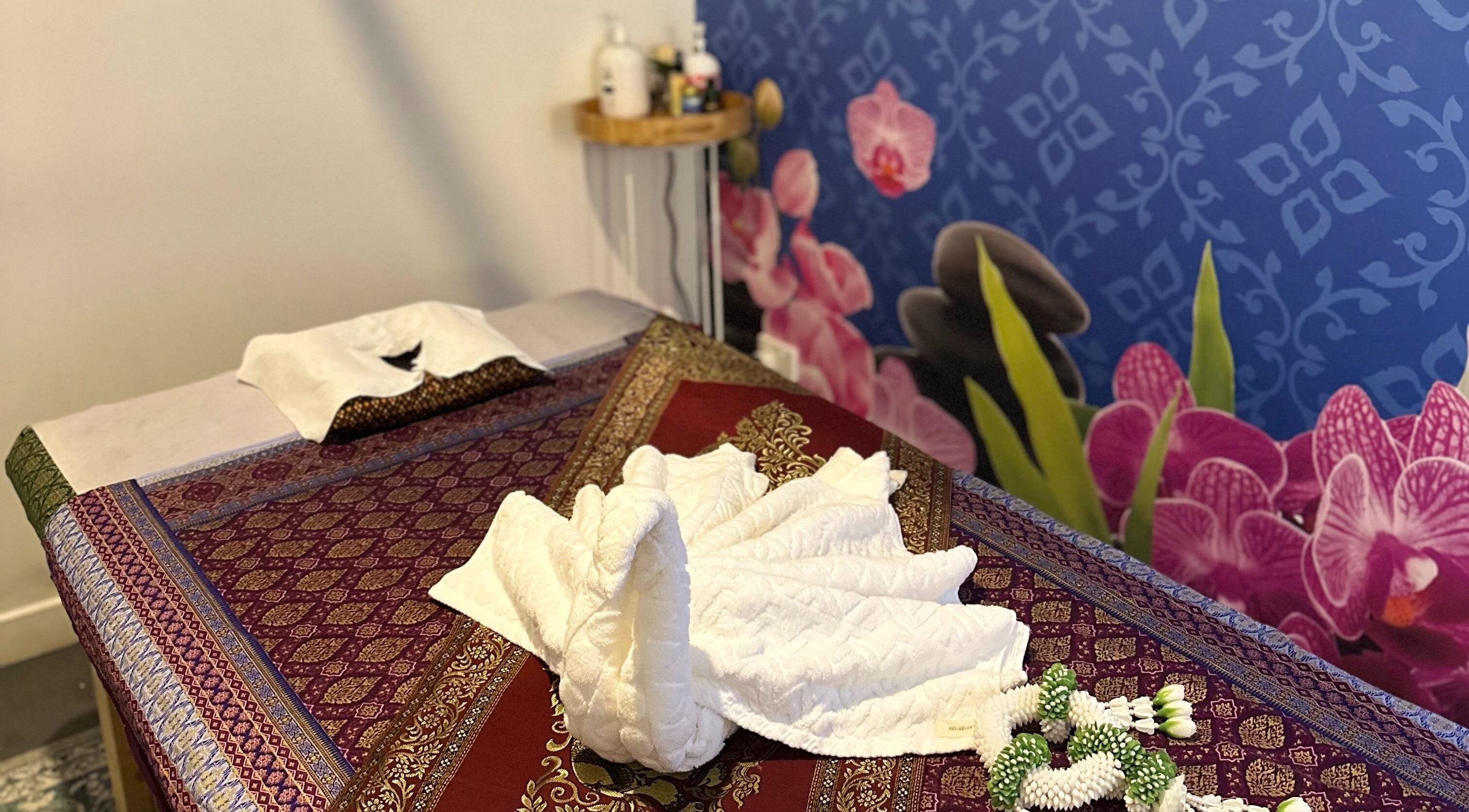 Tranquil massage room at Na-ka Thai Day Spa in Woolloongabba, Queensland, AU with ornate decor and calming ambience.