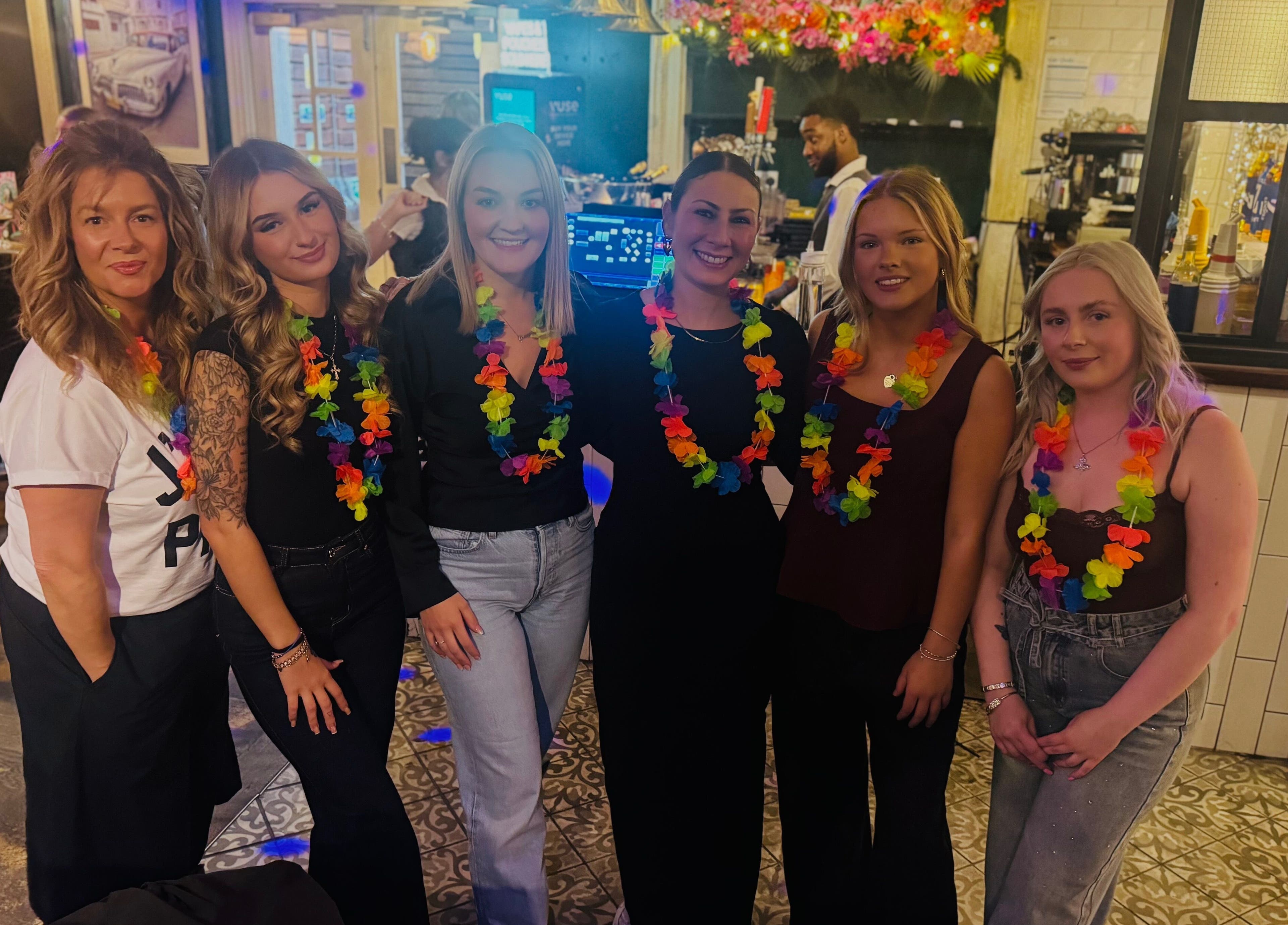 Guests enjoying a lively event at No.4 West Bridgford, West Bridgford, England, GB, adorned with colorful leis.