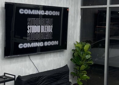 Modern lounge area at Studio Blendz in Southport, Queensland, AU with 'Coming Soon' on TV.