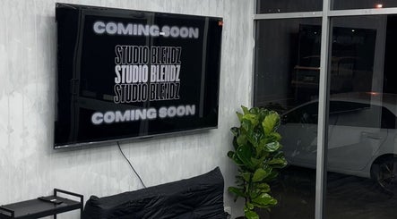Modern lounge area at Studio Blendz in Southport, Queensland, AU with 'Coming Soon' on TV.