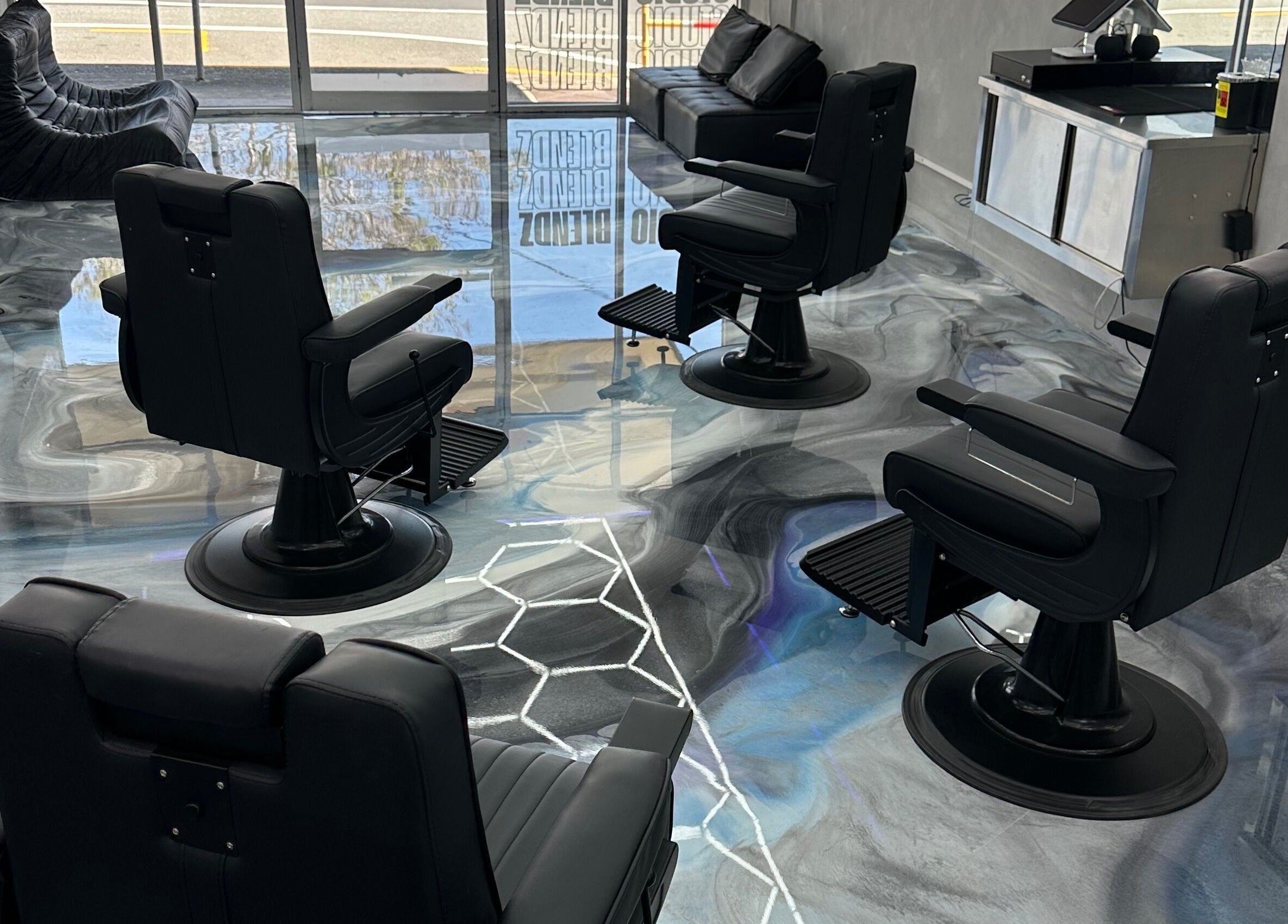 Interior of StudioBlendz Barbershop in Southport, Queensland, AU with stylish black barber chairs and sleek decor.