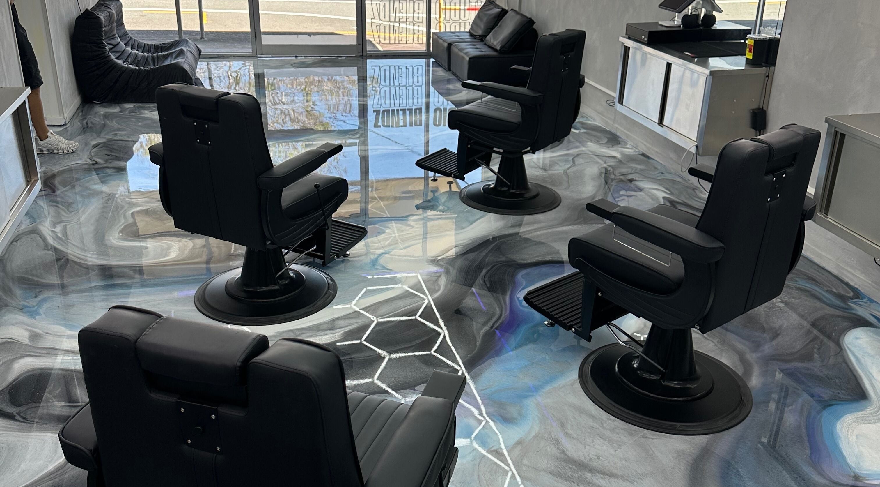 Interior of StudioBlendz Barbershop in Southport, Queensland, AU with stylish black barber chairs and sleek decor.