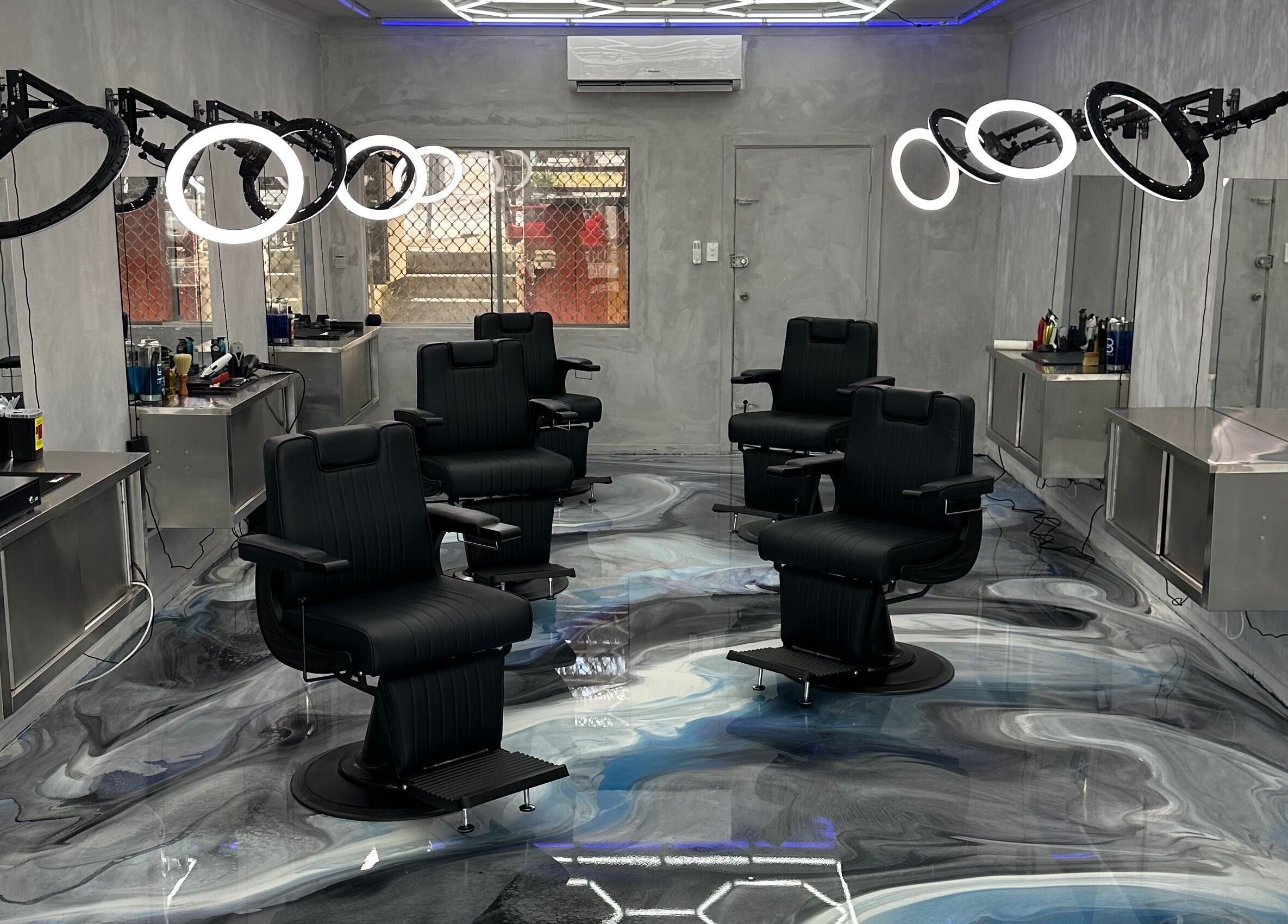 Modern barbershop interior at StudioBlendz Barbershop, Southport, Queensland, AU with sleek chairs and bright lighting.