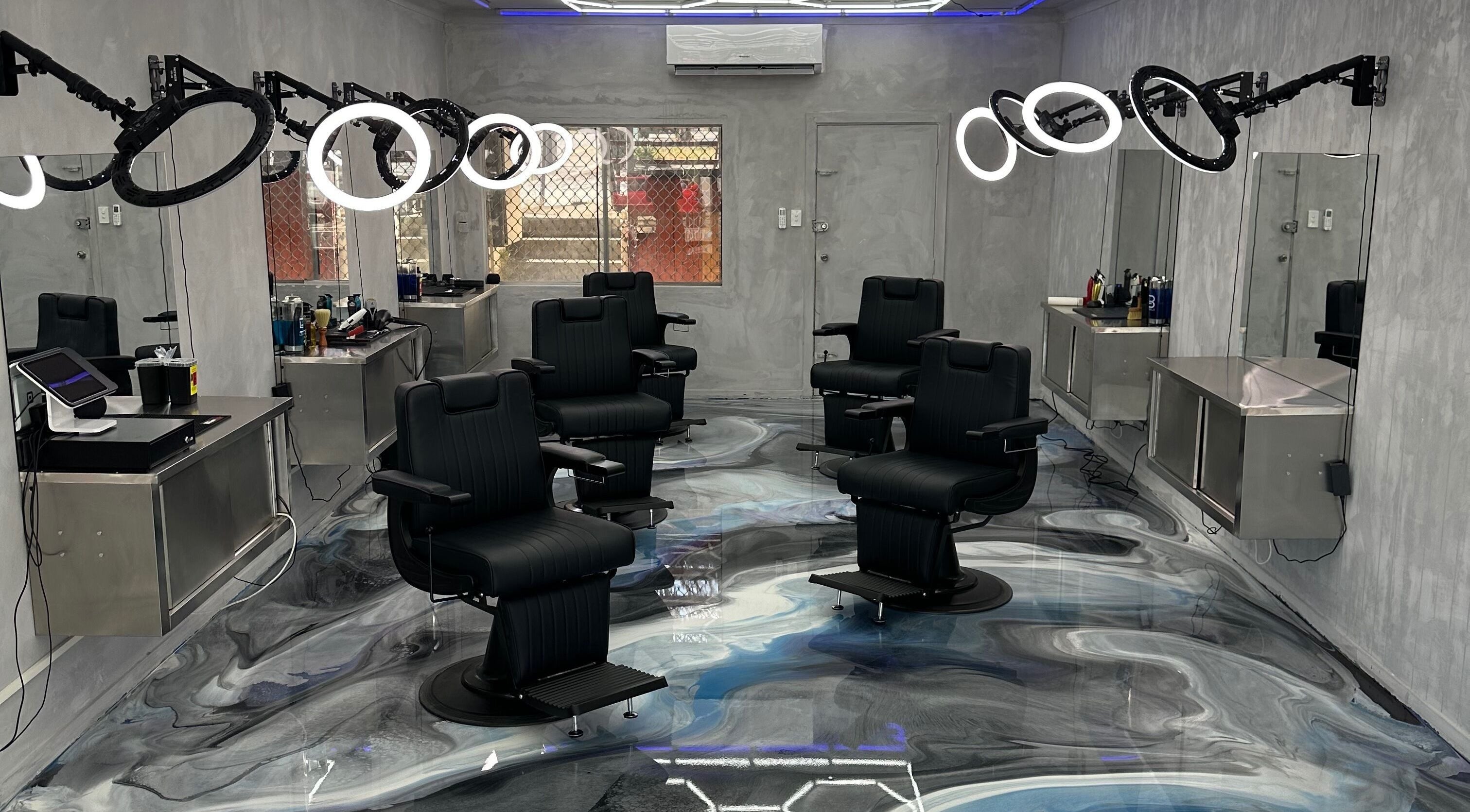 Modern barbershop interior at StudioBlendz Barbershop, Southport, Queensland, AU with sleek chairs and bright lighting.