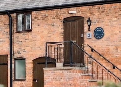 Entrance of Birch Barn Therapies, a serene brick building in Castlethorpe, England, GB.