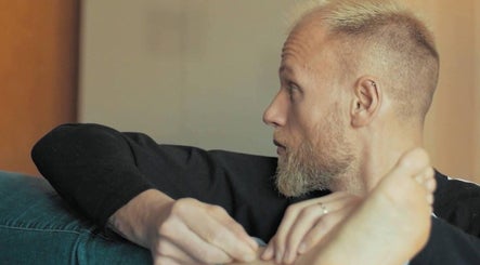 Man enjoying a foot massage at Birch Barn Therapies in Castlethorpe, England, GB for relaxation.