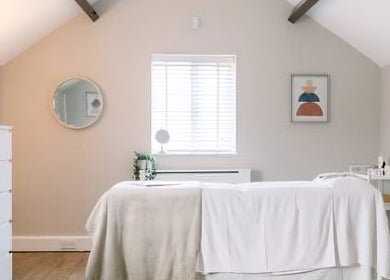 Relaxing treatment room at Birch Barn Therapies, Castlethorpe, England, GB with massage table and warm decor.
