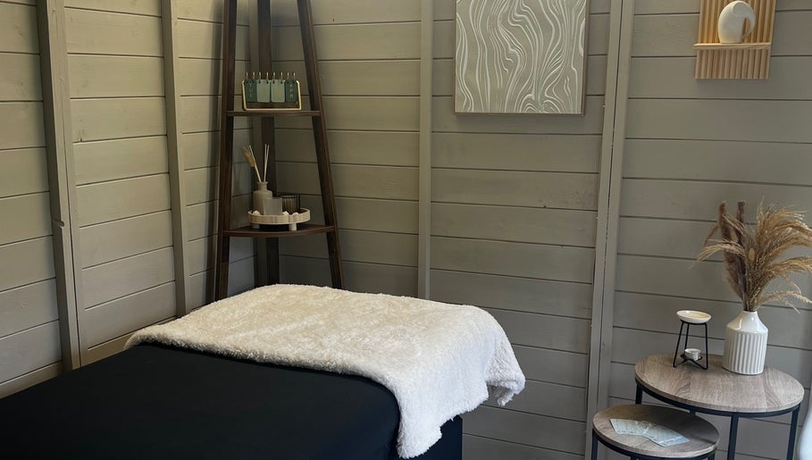 Relaxing massage bed at Izzy’s Beauty Room in Gloucester, England, GB with serene decor and soft lighting.