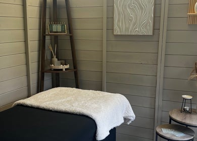 Relaxing massage bed at Izzy’s Beauty Room in Gloucester, England, GB with serene decor and soft lighting.