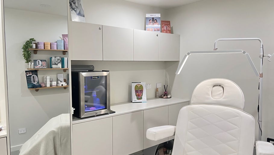 Modern treatment room at Aesthetics By Kristen, Wollongong, New South Wales, AU, featuring elegant white decor.