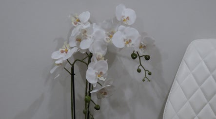 White orchids creating a serene atmosphere at Aesthetics By Kristen in Wollongong, New South Wales, AU.