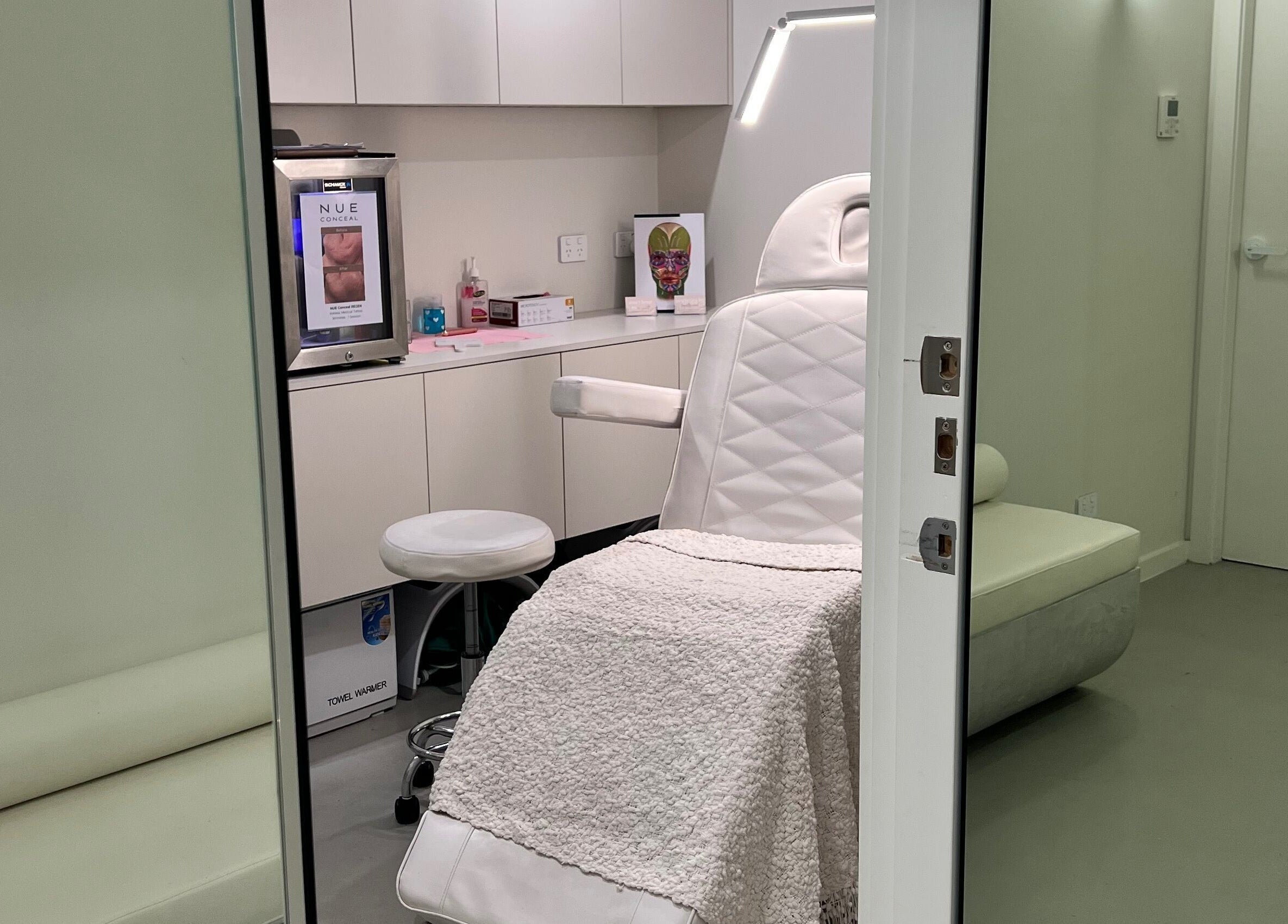 Elegant treatment room at Aesthetics By Kristen, Wollongong, New South Wales, AU with plush seating.
