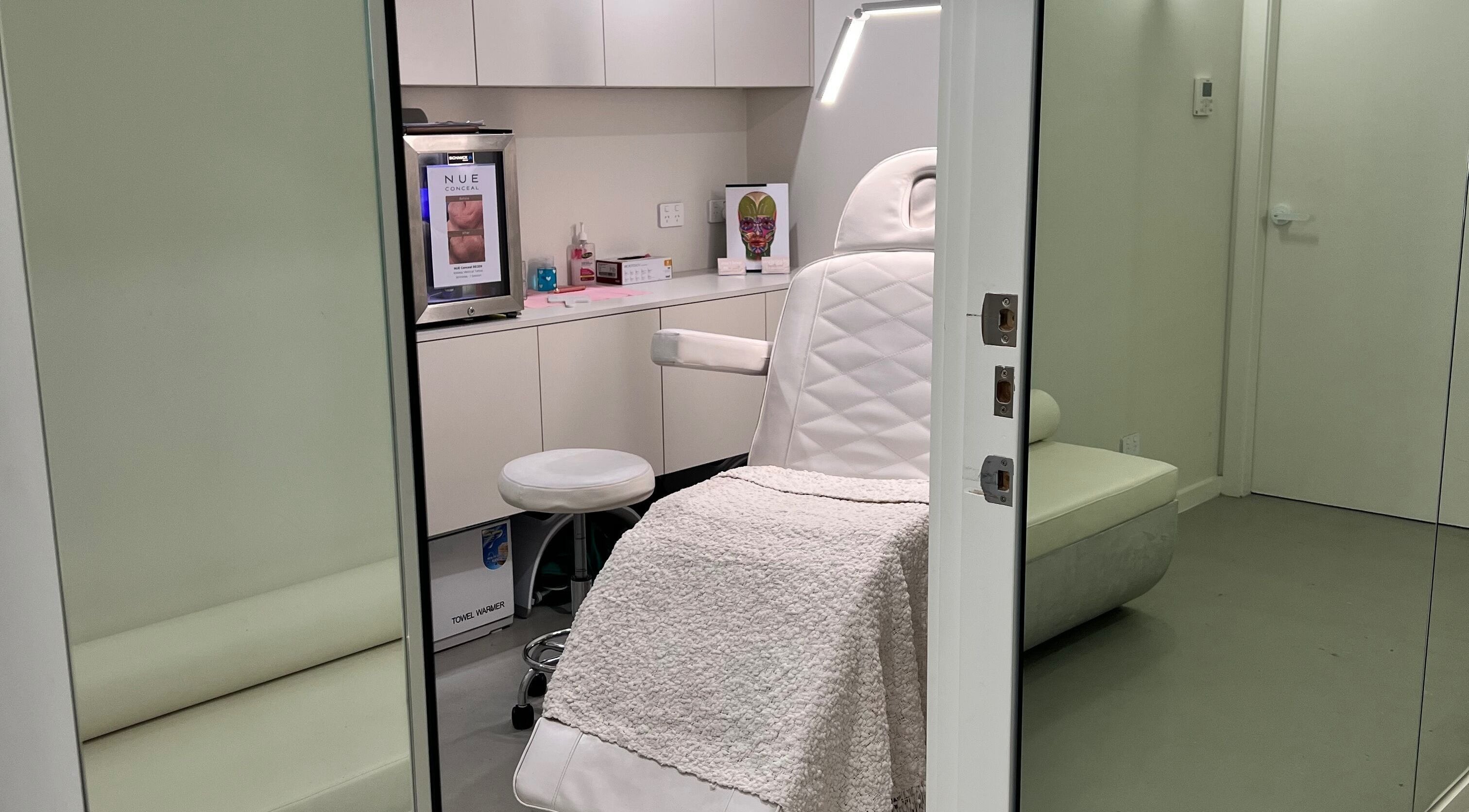 Elegant treatment room at Aesthetics By Kristen, Wollongong, New South Wales, AU with plush seating.