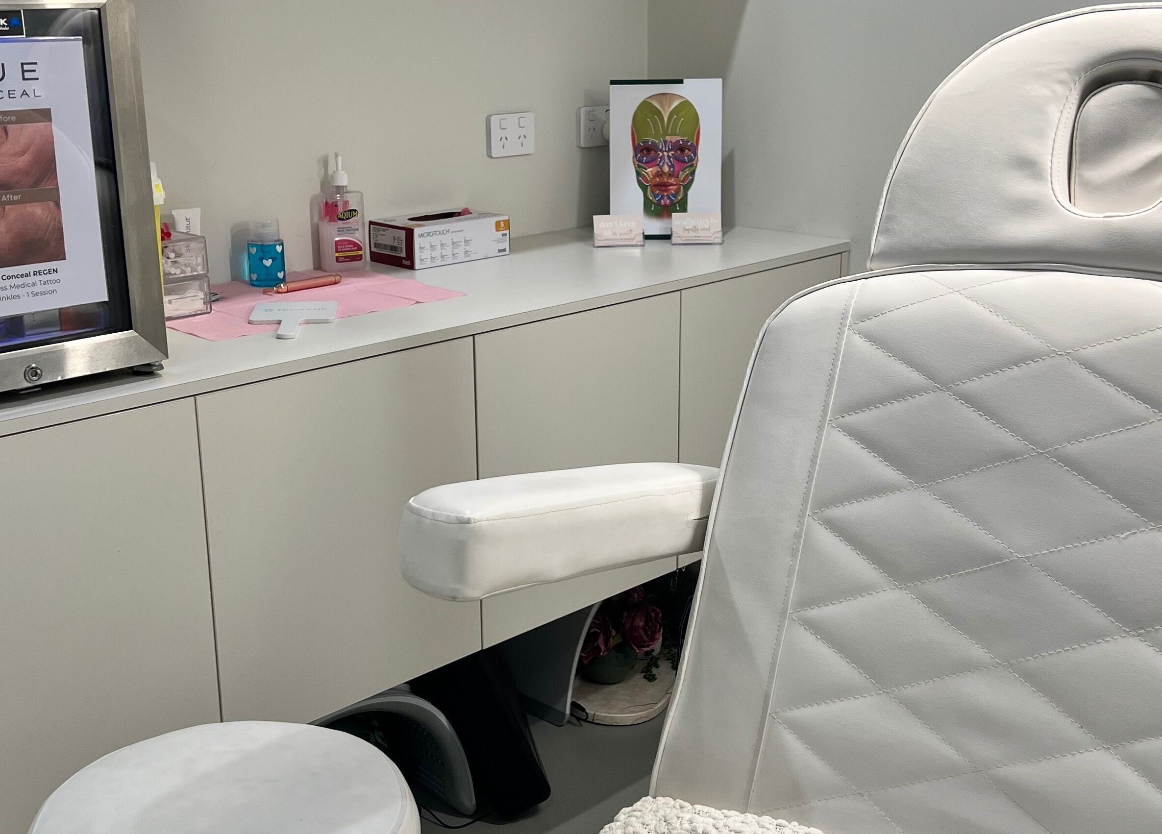 Elegant treatment room at Aesthetics By Kristen, Wollongong, New South Wales, AU featuring a plush white chair.