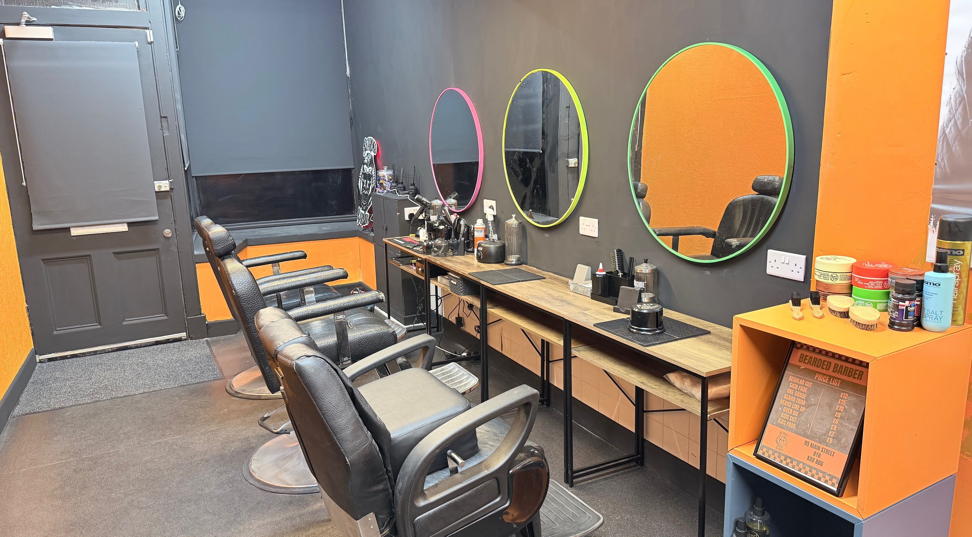Interior of Bearded Barber in Ayrshire, Scotland, GB with stylish chairs and vibrant mirrors.