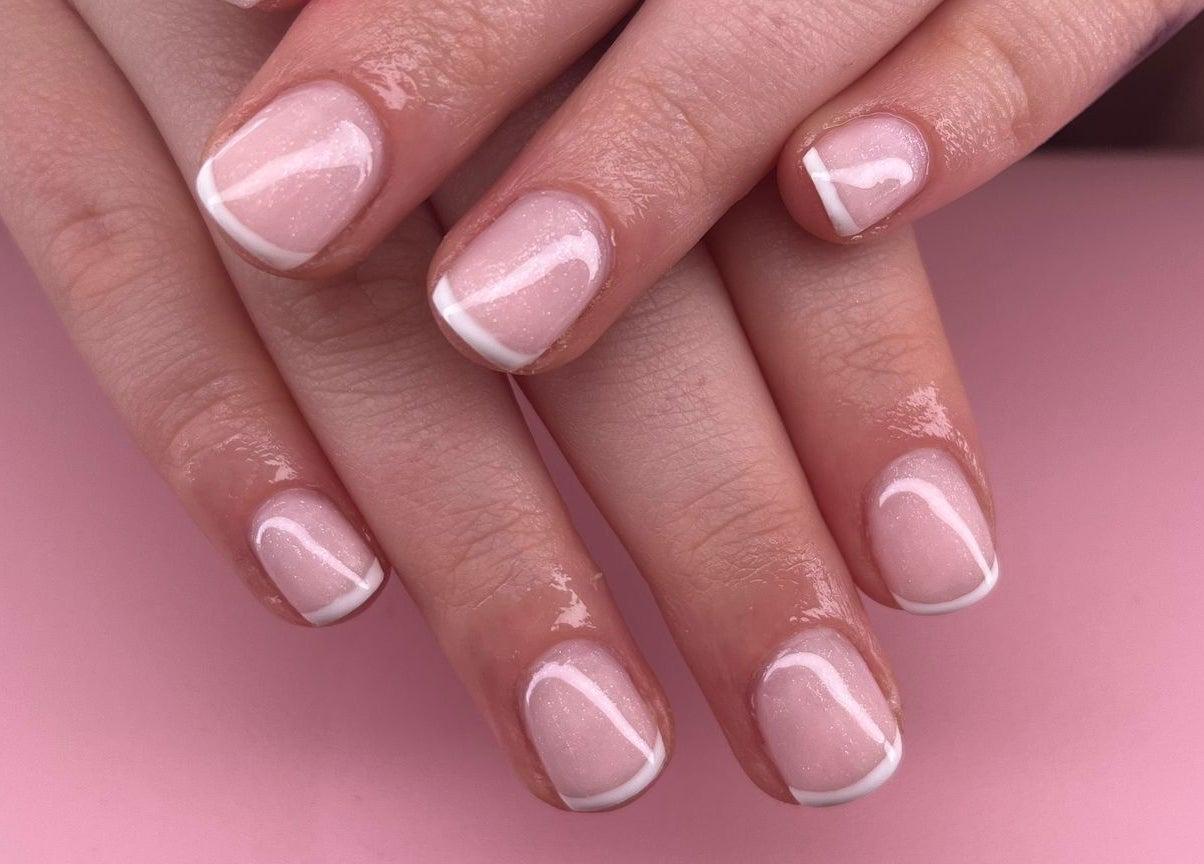Elegant manicured nails at Glambox, Norwich, England, GB on a stylish pink backdrop.