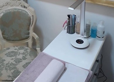 Elegant nail station at Pretty Nails Nottingham, Arnold, England, GB, featuring chic chair and manicure tools.