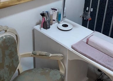 Elegant nail station at Pretty Nails Nottingham, Arnold, England, GB, featuring ornate chair and manicure setup.