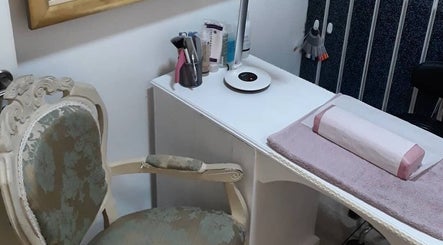 Elegant nail station at Pretty Nails Nottingham, Arnold, England, GB, featuring ornate chair and manicure setup.