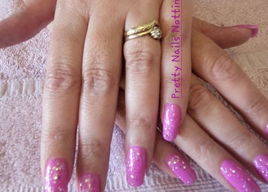 Glamorous pink glitter manicure at Pretty Nails Nottingham, Arnold, England, GB, showcasing elegant design.