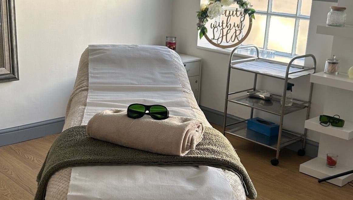 Relaxing treatment room at Tease 2, Hazel Grove, England, GB, featuring a cozy massage bed.