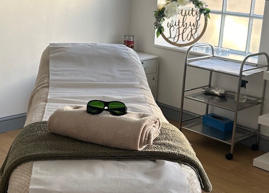 Relaxing treatment room at Tease 2, Hazel Grove, England, GB, featuring a cozy massage bed.