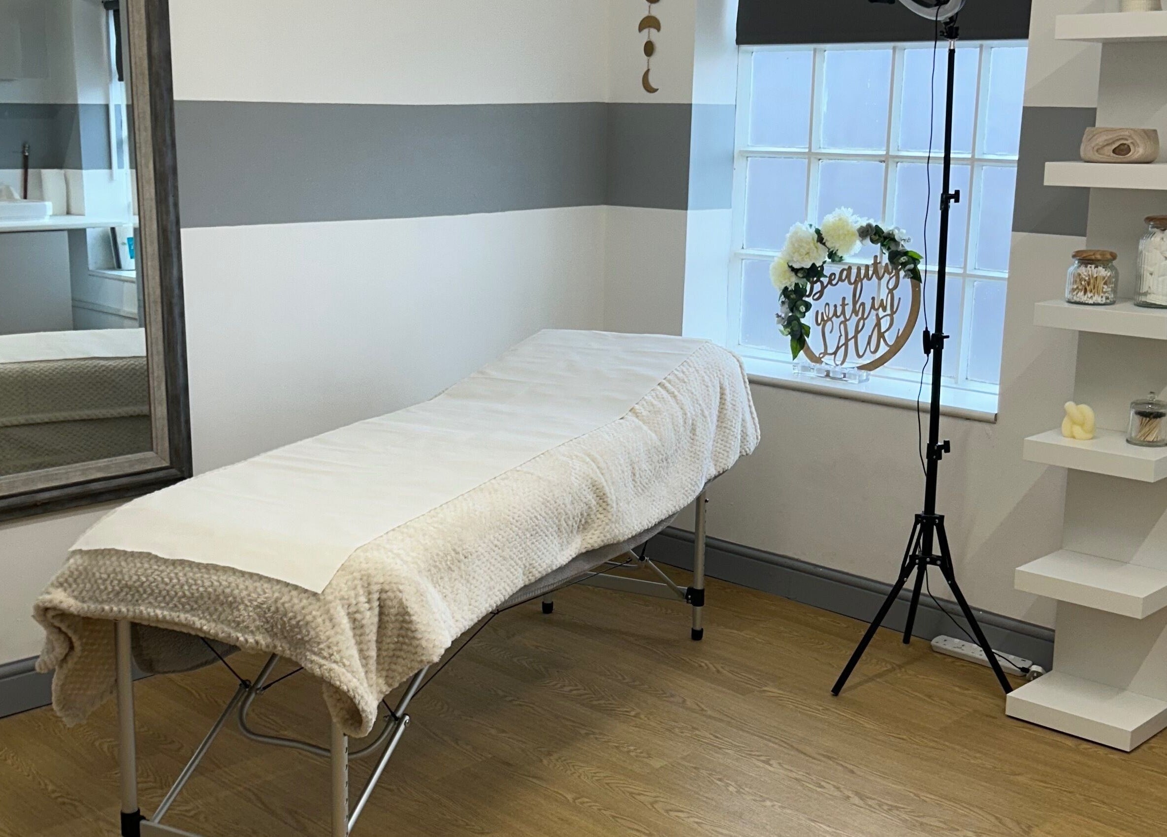 Serene treatment room at Tease 2, Hazel Grove, England, GB with cozy bed and elegant decor.