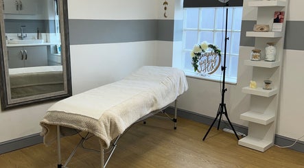 Serene treatment room at Tease 2, Hazel Grove, England, GB with cozy bed and elegant decor.