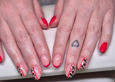 Stylish nail designs with red and animal print at Nails with Love, Willenhall, England, GB.