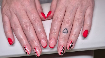 Stylish nail designs with red and animal print at Nails with Love, Willenhall, England, GB.
