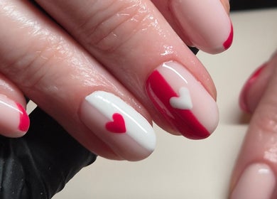 Heart-themed nail art at Nails with Love, Willenhall, England, GB, showcasing red and white designs.