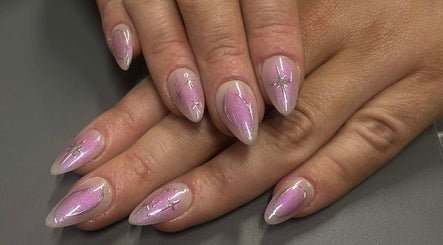 Elegant pink manicure with star accents at Esthers Glam On Wheels, Aberystwyth, Wales, GB.