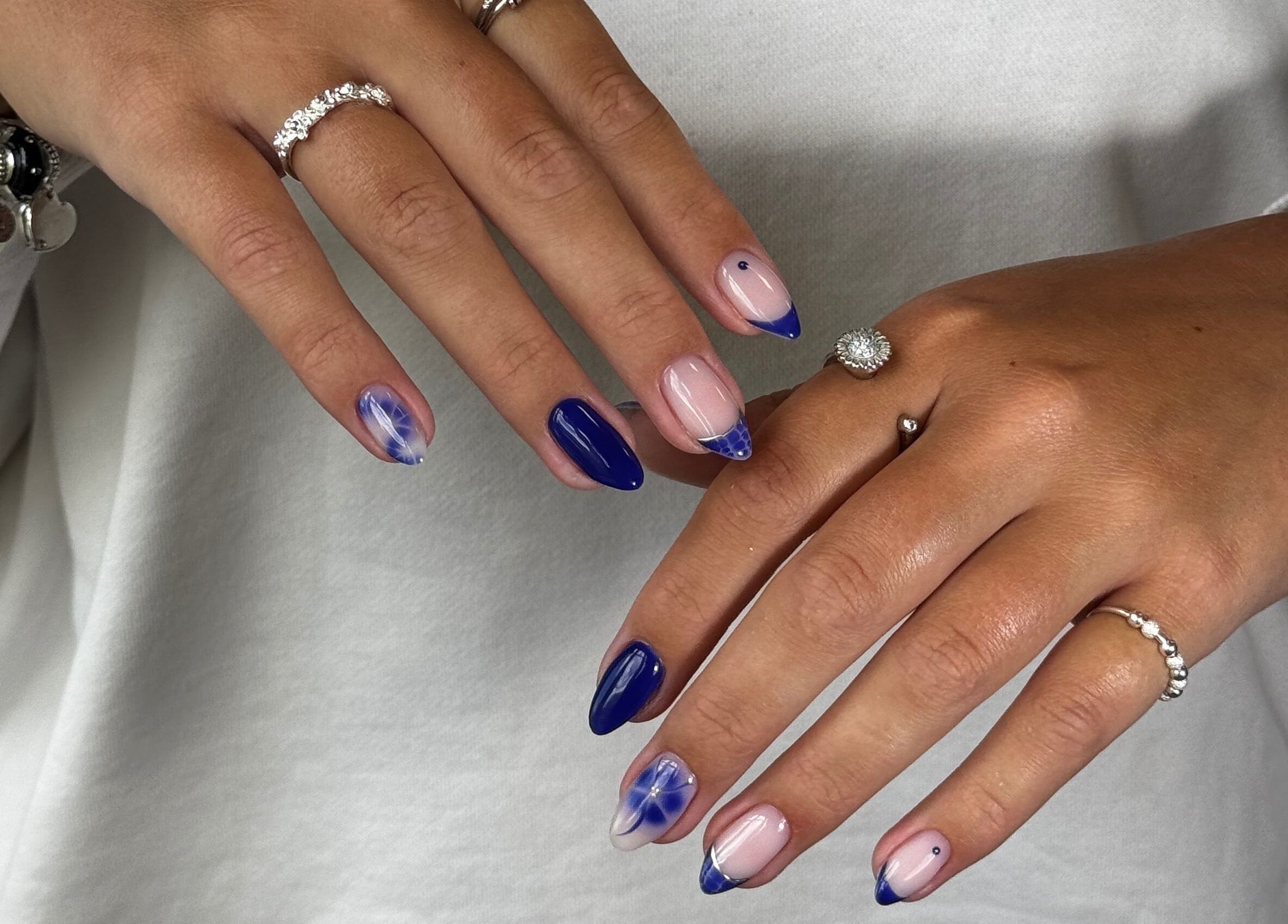 Close-up of artistic blue and nude nail design from Fabulous Nails in Melbourne, Victoria, AU.