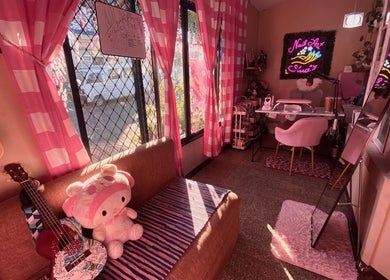 Chic cozy interior of Bling On Me Nail Art Studio, Tayabas, Calabarzon, PH, featuring pink decor and plush seating.
