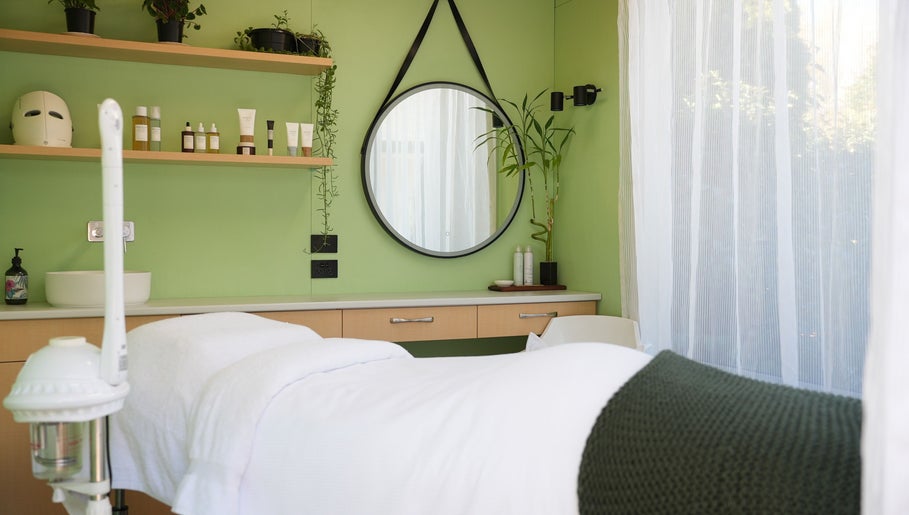 Relaxing treatment room at Hada Studio, Christchurch, Canterbury, NZ with a calming green interior.