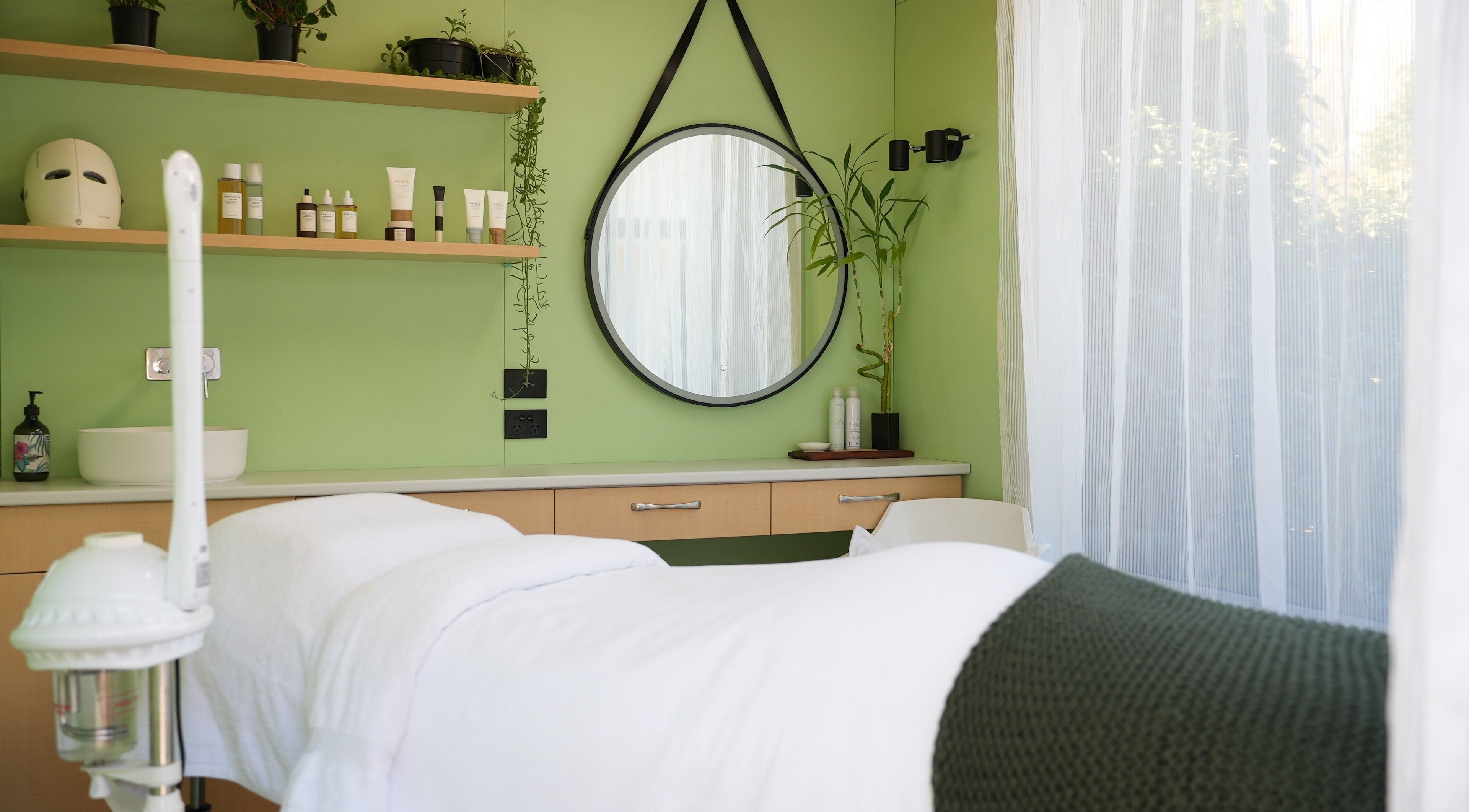 Relaxing treatment room at Hada Studio, Christchurch, Canterbury, NZ with a calming green interior.