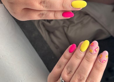 Colorful nail designs at Rock Candy Beauty, Louth, England, GB. Vibrant yellow and pink manicure.