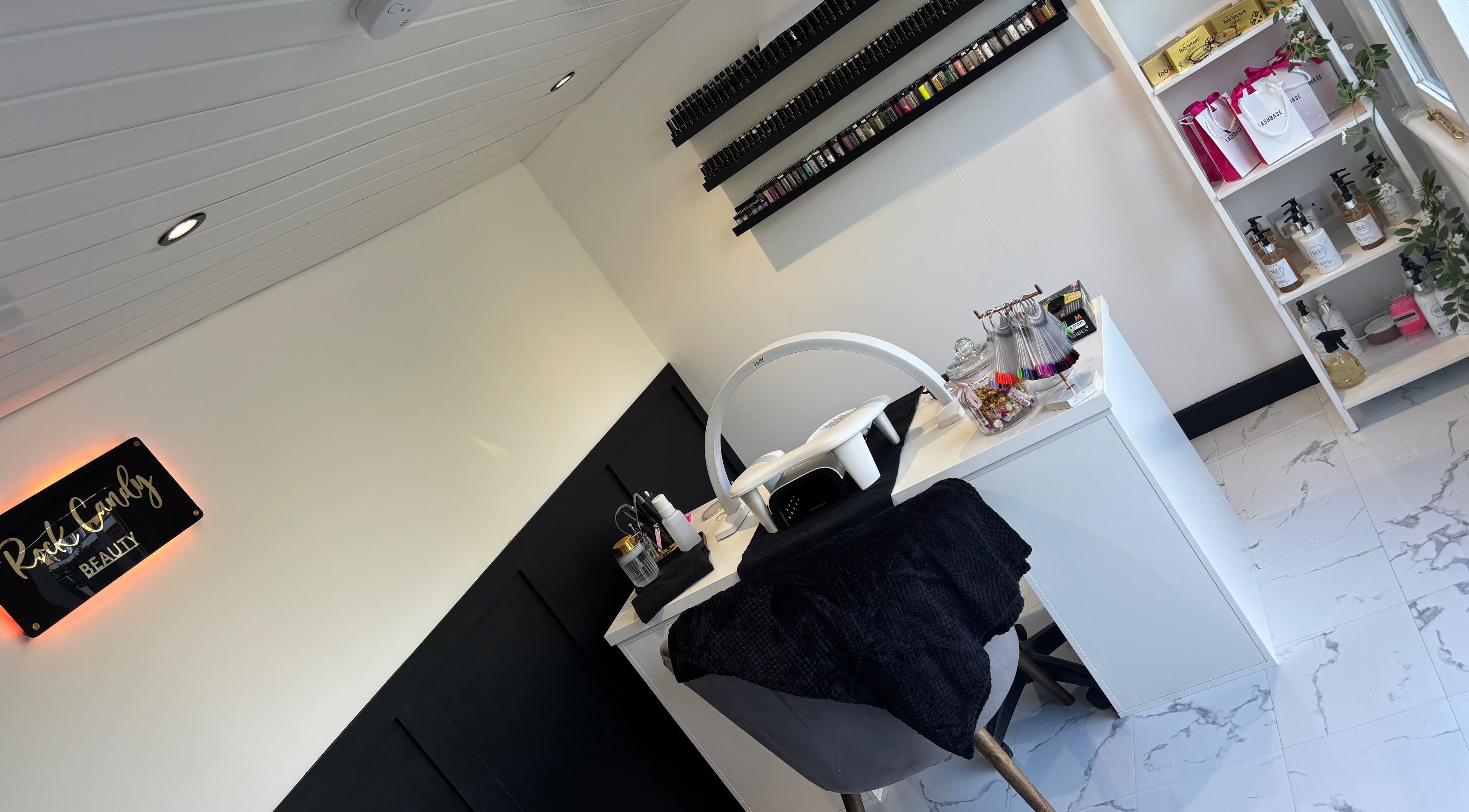 Chic nail station at Rock Candy Beauty, Louth, England, GB with nail polishes and treatment tools.