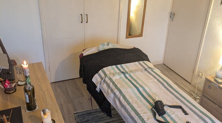 Cozy treatment room at Reviving Harmony, London, England, GB, ready for relaxation therapy.