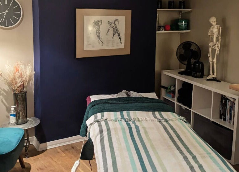 Cozy therapy room at Reviving Harmony in London, England, GB, featuring a treatment bed and calm decor.