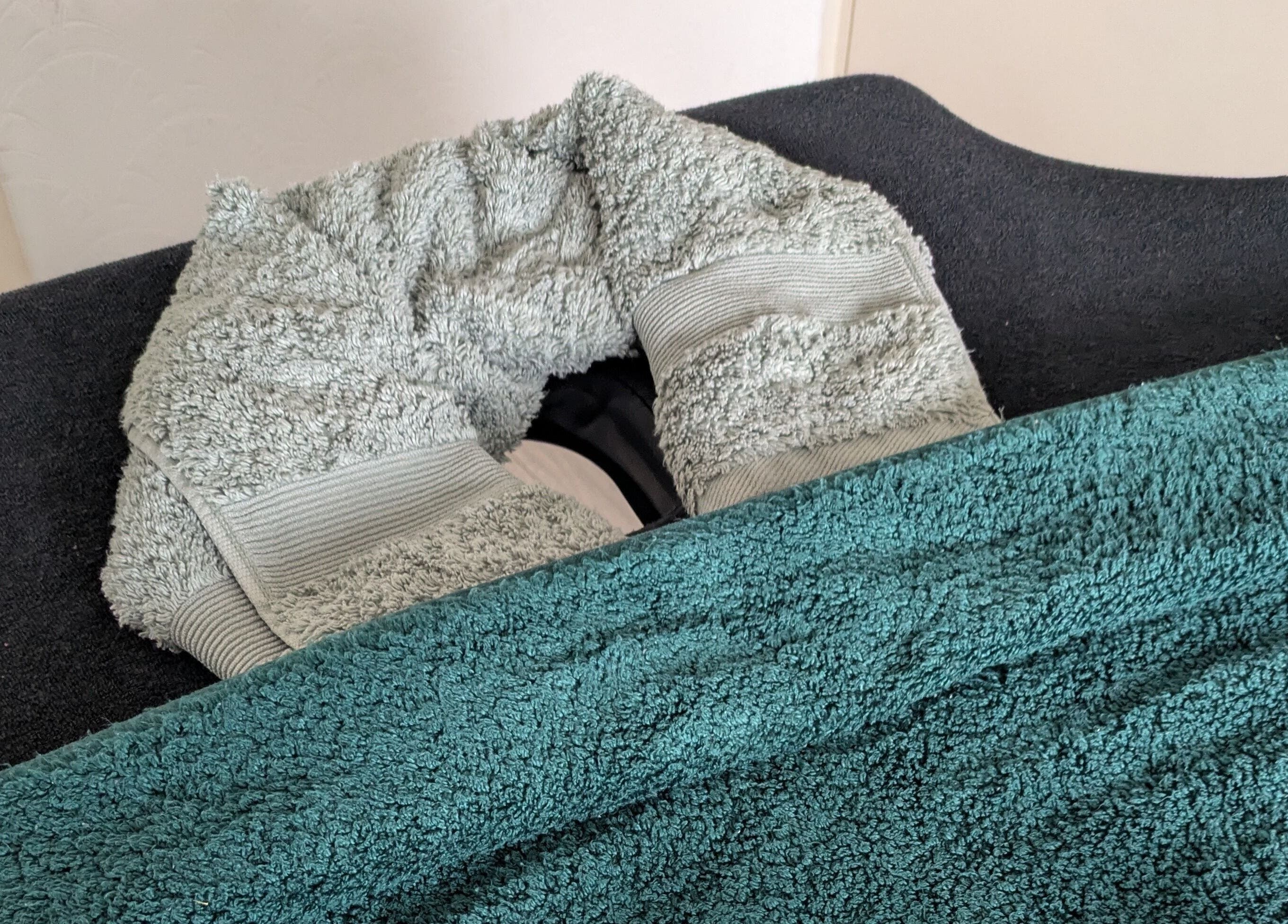 Well-prepared massage table at Reviving Harmony, London, England, GB, featuring plush towels and cozy linens.