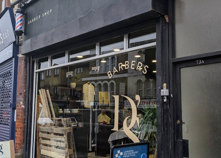 Exterior of Reviving Harmony barber shop in London. Check emails for booking information before you travel.