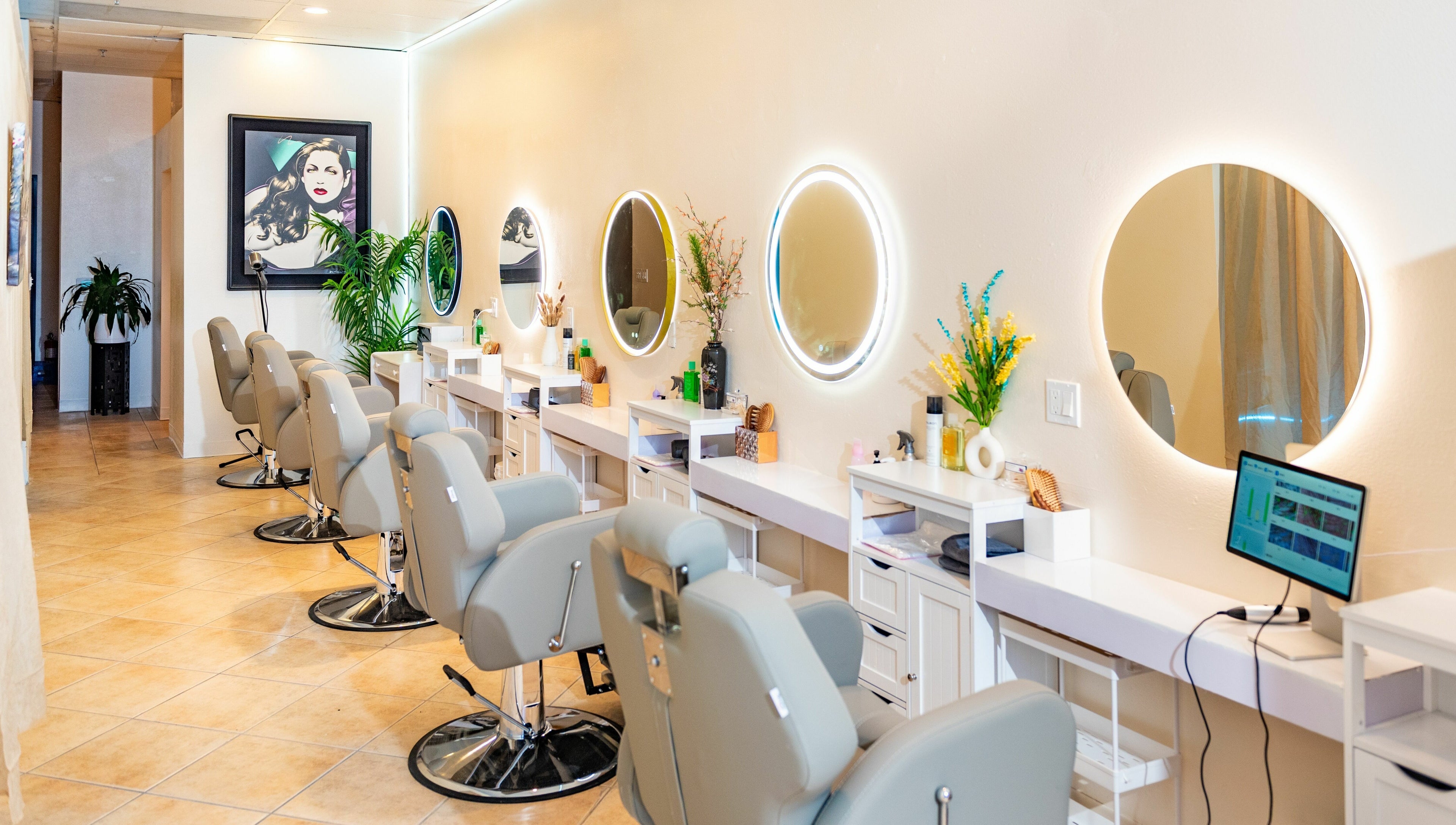 Modern hair salon interior at Siyu Hair SPA in Henderson, Nevada, US with stylish chairs and illuminated mirrors.