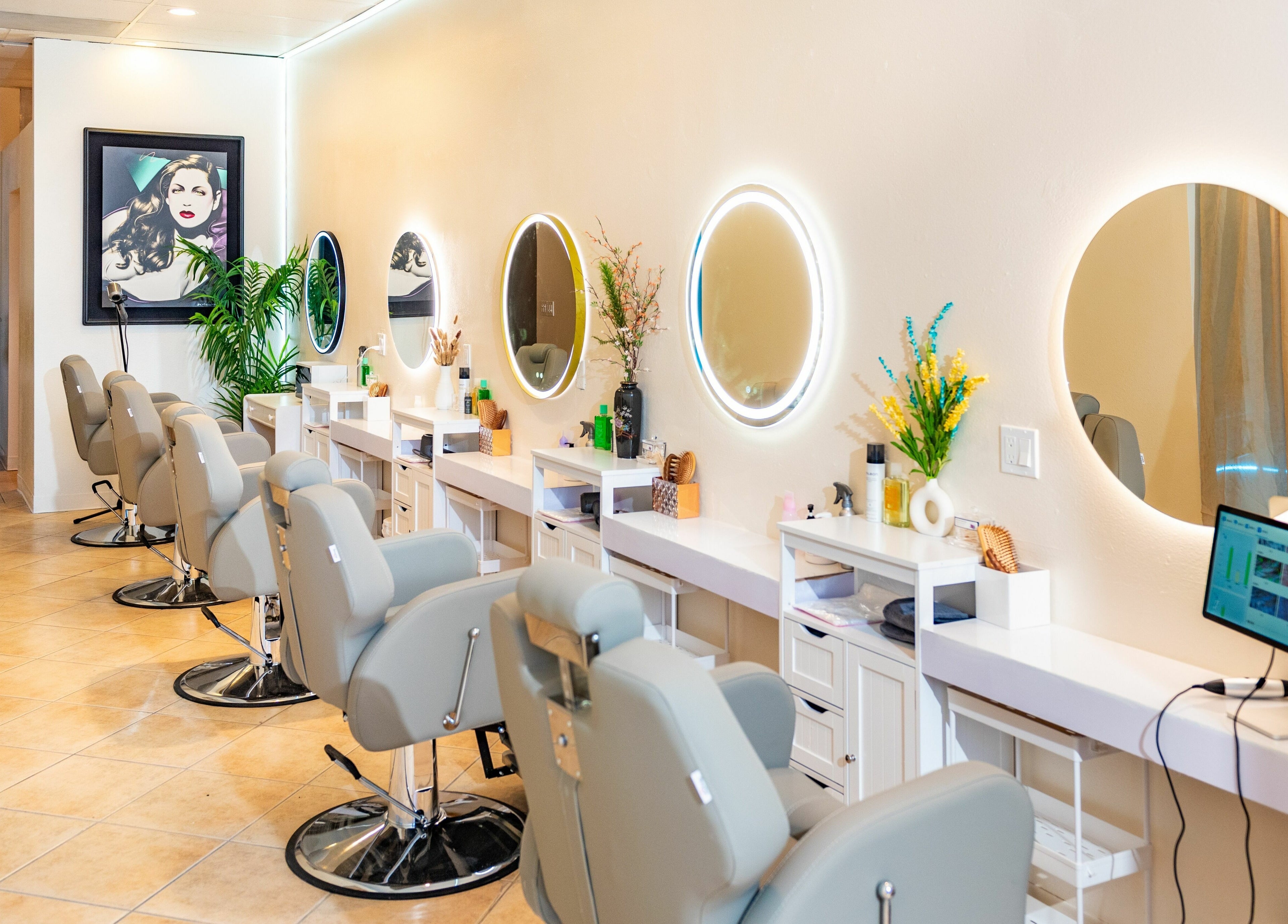 Modern hair salon interior at Siyu Hair SPA in Henderson, Nevada, US with stylish chairs and illuminated mirrors.