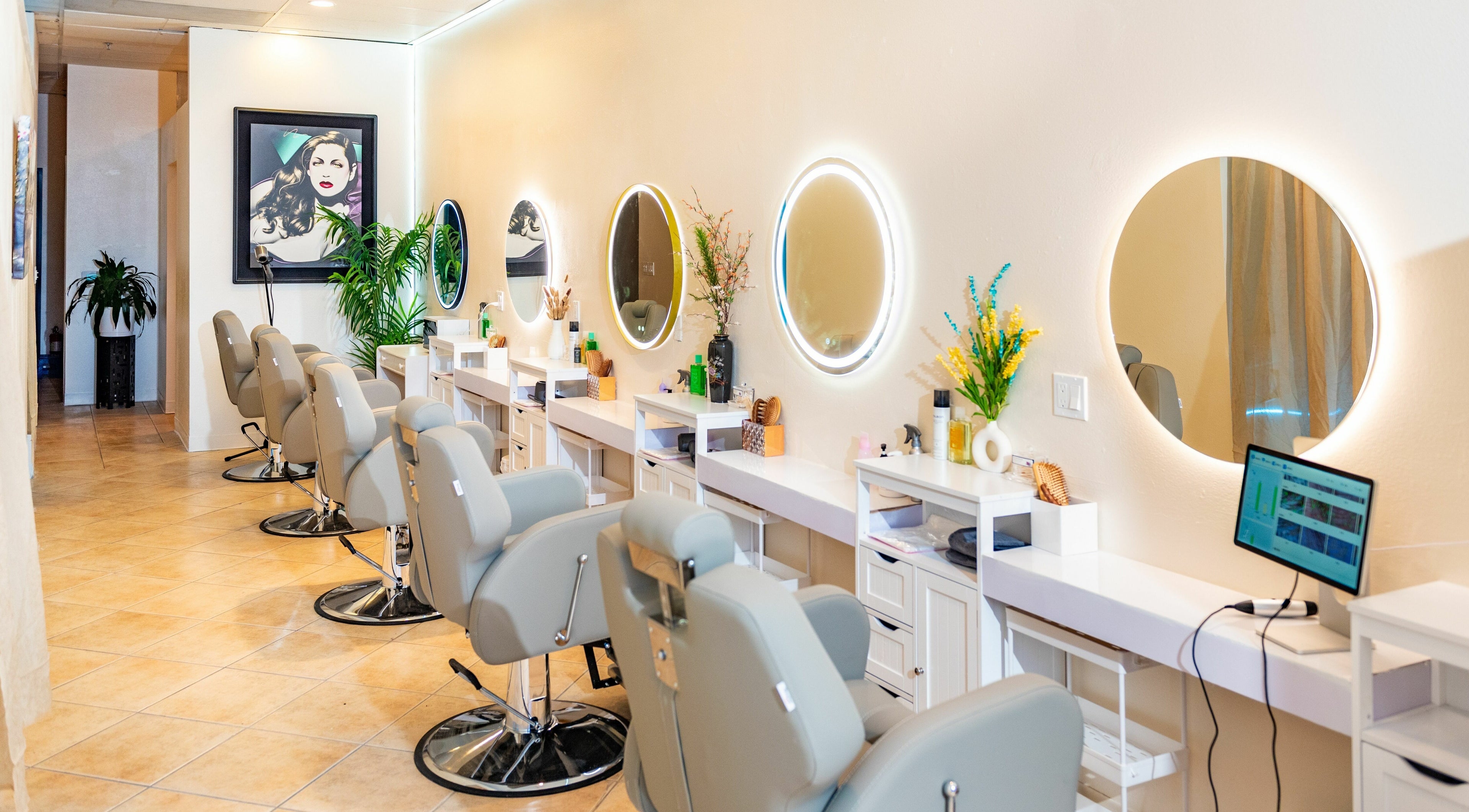 Modern hair salon interior at Siyu Hair SPA in Henderson, Nevada, US with stylish chairs and illuminated mirrors.