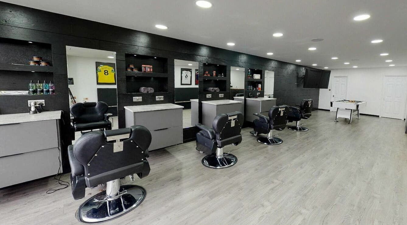 Modern interior of Kings Cuts in Epsom, England, GB with stylish barber chairs and mirrors.